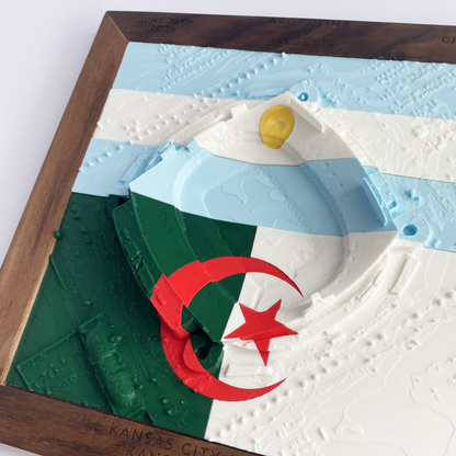 3D printed model of Arrowhead Stadium imprinted with Argentina's flag on the top half and Algeria's flag on the bottom half - encased in a solid wooden frame engraved with the text "June 26th 2026; Argentina v Algeria; Group J, Kansas City Stadium, Kansas City, MO, and coordinates"