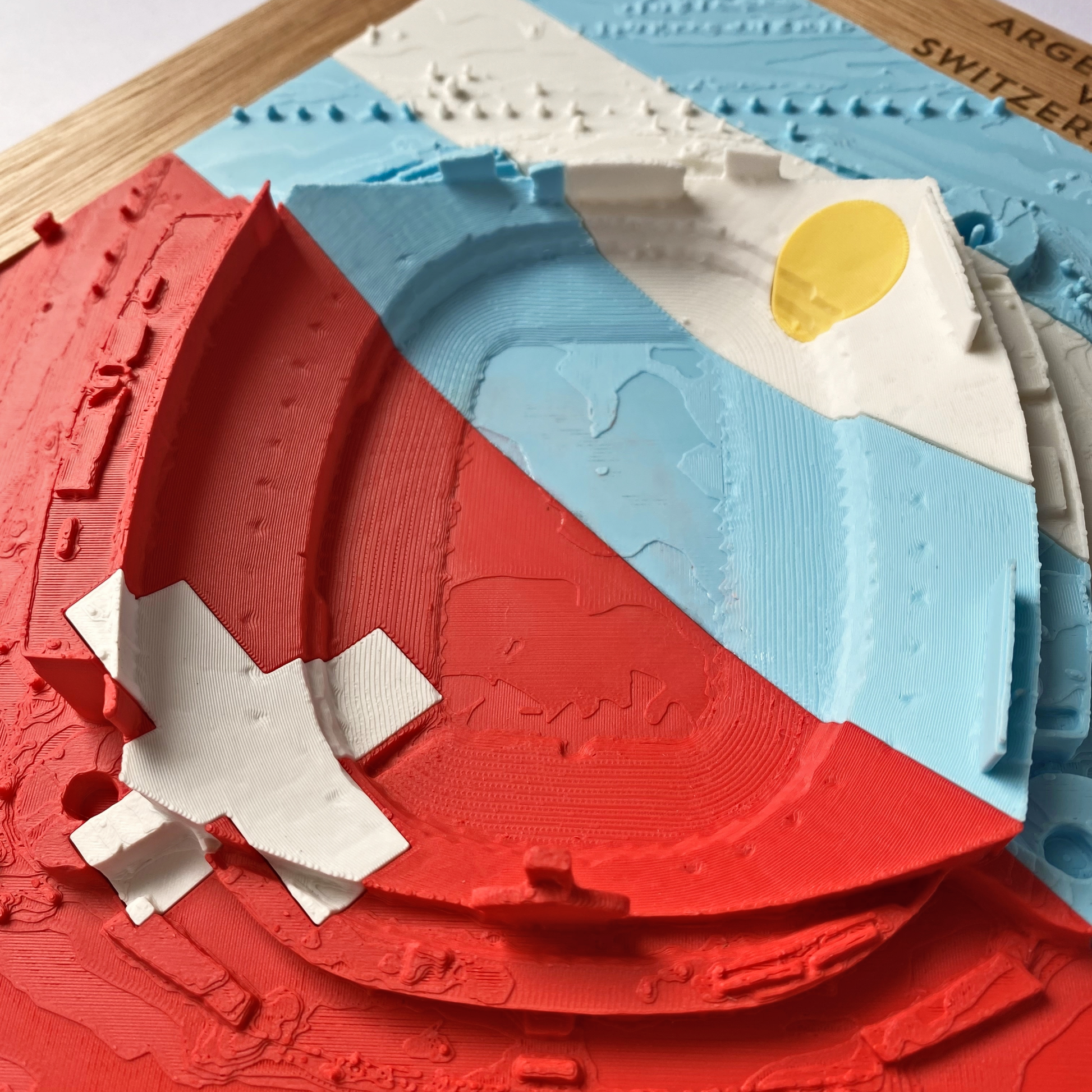 A zoomed in view of a relief map of Arrowhead Stadium overlaid with the flag colors and designs of Argentina and Switzerland