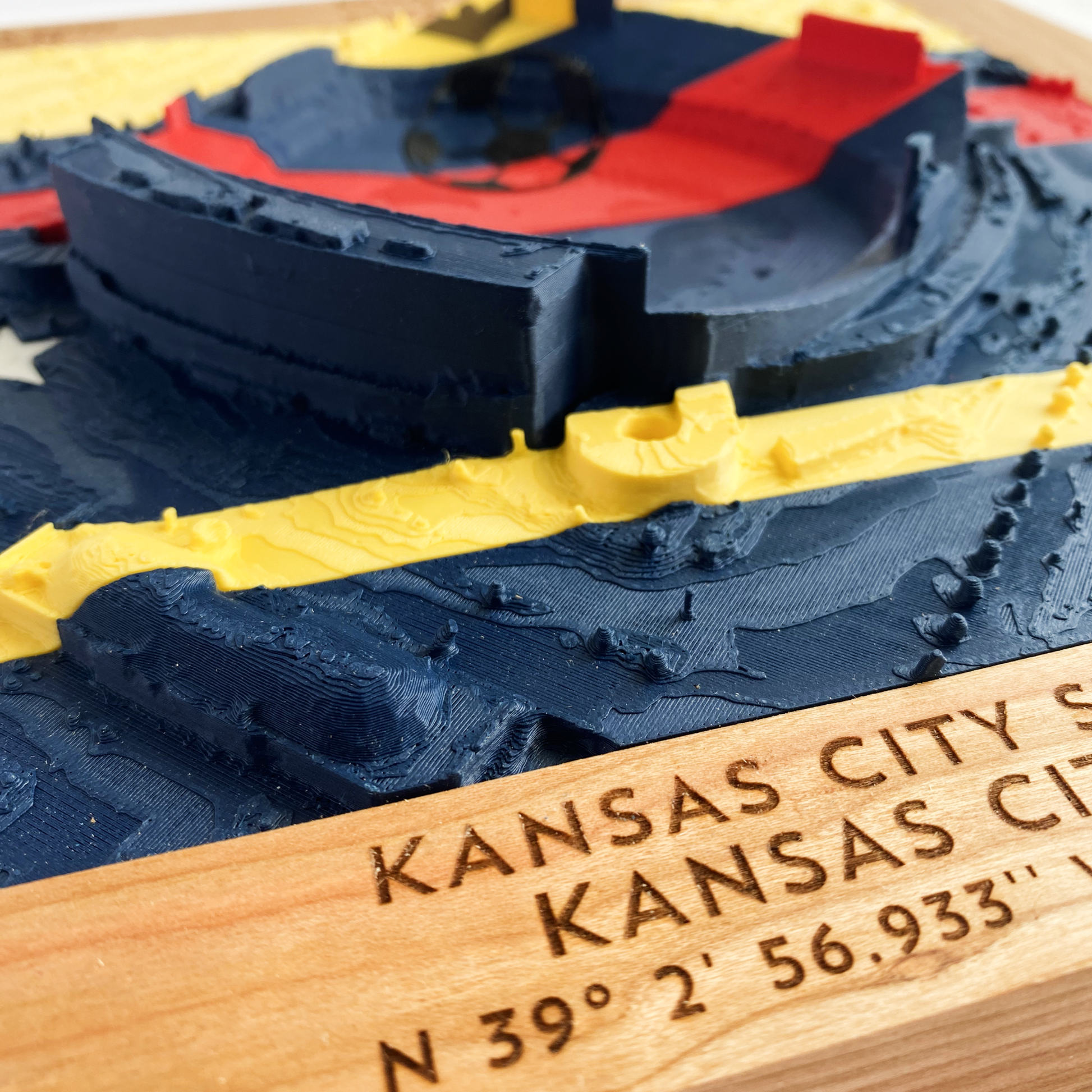 3D printed model of Arrowhead Stadium imprinted with Ecuador's flag on the top half and Curacao's flag on the bottom half - encased in a solid wooden frame engraved with the text "June 20th 2026; Ecuador v Curacao; Group E; Kansas City Stadium, Kansas City, MO, and coordinates"