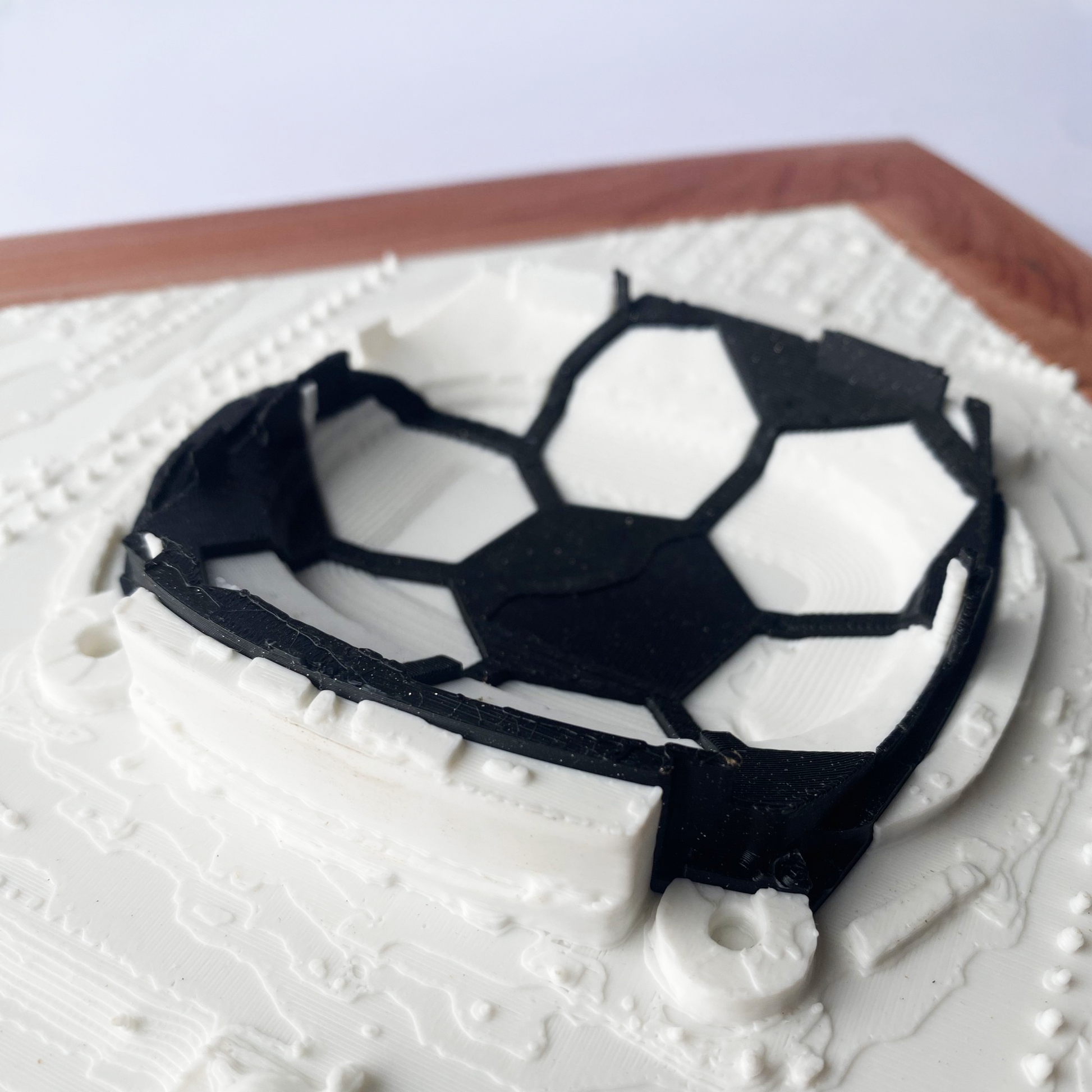 Framed 3D rendering of Arrowhead Stadium with heart-shaped black and white inlay in a soccer ball design